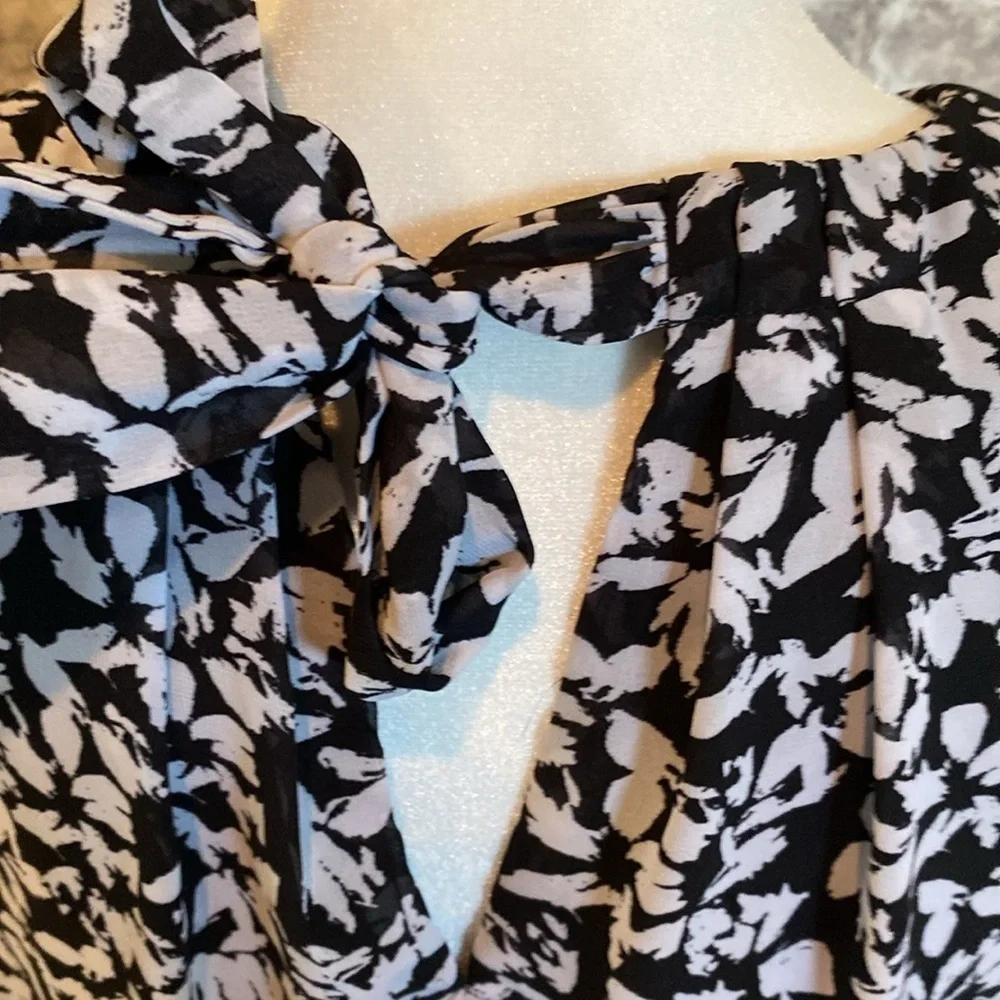 Karin Steven’s sleeveless black/white patterned lined dress. Tie at neck & waist